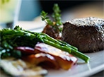 View Nutritional Info A petite filet with zucchini, broccolini and bacon onion jam